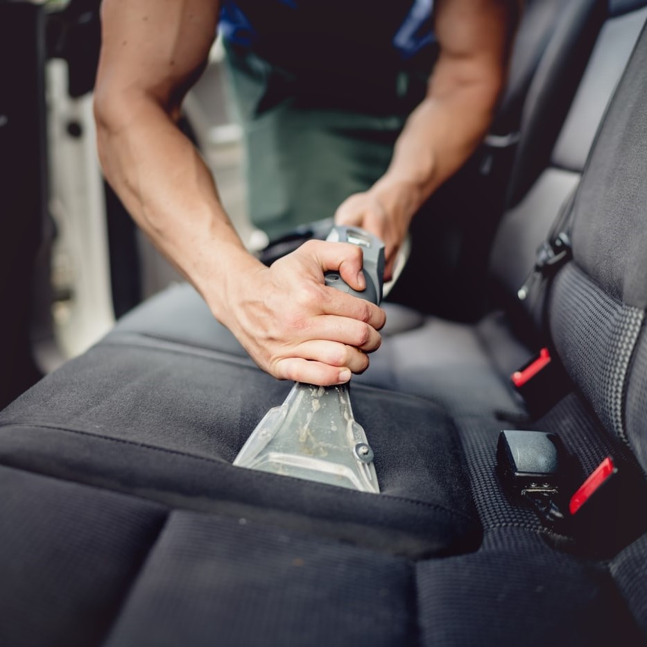 Professional car seat shampoo and upholstery cleaning service in Queens NY using steam extraction tool